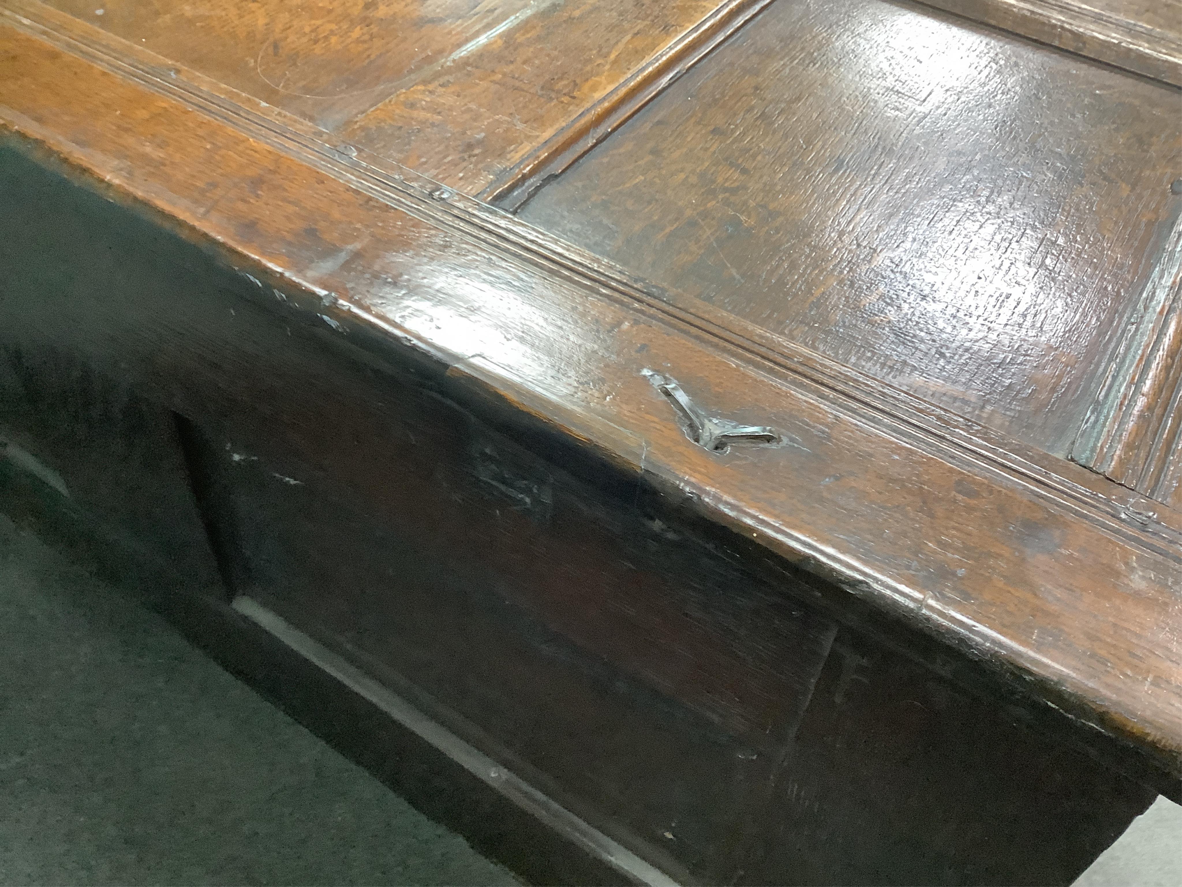 An oak coffer with three panels carved with roundels, width 106cm, depth 47cm, height 61cm